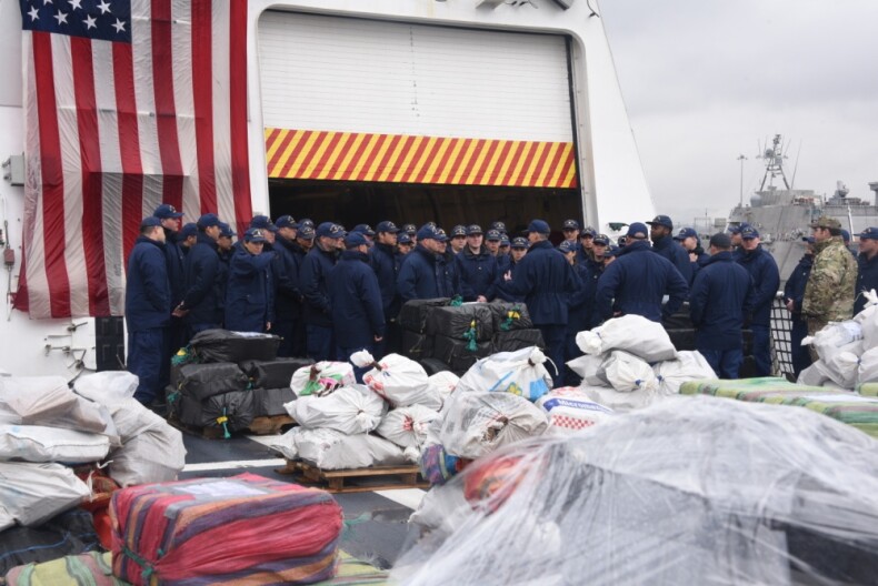 Coast Guardsmen gather together before preparing bails of cocaine to be offloaded from the Coast Guard Cutter Munro in San Diego, Feb. 10, 2020. The crew aboard the Munro offloaded approximately 20,000 pounds of cocaine.