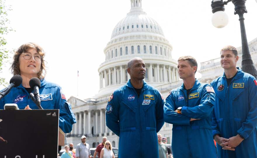 NASA Astronaut Christina Hammock Koch (L) speaks alongside fellow members of the crew of the Artemis II mission, with NASA astronauts Victor Glover (L) and Reid Wiseman (C), along with Canadian Space Agency astronaut Jeremy Hansen (R) outside the U.S. Capitol in Washington, D.C., on May 18, 2023.