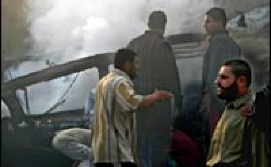 Smoke billows from the site where a car bomb exploded in a local market in Baghdad's poor neighborhood of Sadr City, March 12, 2006.