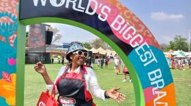 A woman poses at Loftus Versfeld Stadium in Pretoria where thousands of South Africans gathered on 24 September, 2026, to try and break the Guinness World Record for the biggest ever braai, or barbecue.