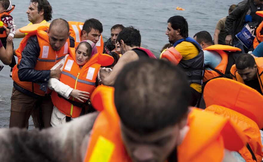 Syrian refugees arrive on the Greek island of Lesbos after crossing the Aegean Sea from Turkey on Tuesday, Sept. 22, 2015.