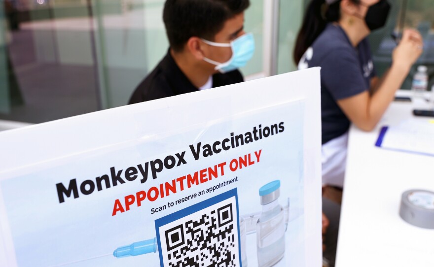 Health workers sit at a check-in table at a pop-up mpox vaccination clinic which opened today by the Los Angeles County Department of Public Health at the West Hollywood Library on August 3, 2022 in West Hollywood, California. California Governor Gavin Newsom declared a state of emergency on August 1st over the mpox outbreak.