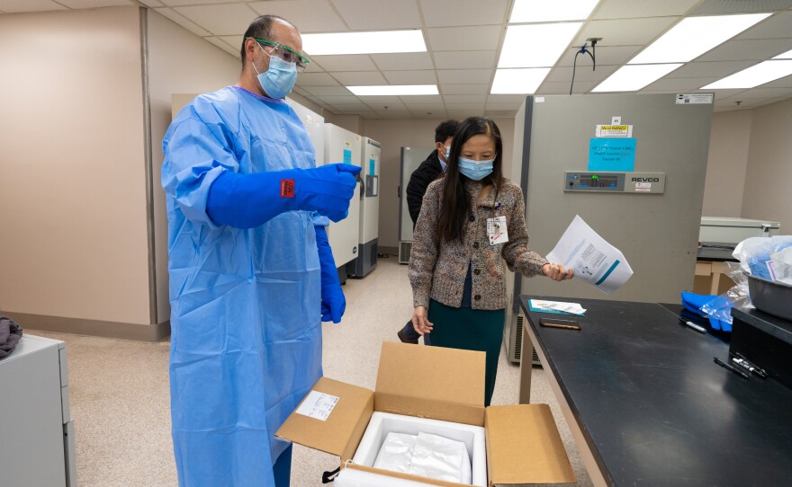 The UC San Diego Health Pharmacy team unpacks the first shipment of Pfizer-BioNtech COVID-19 vaccine, moving the doses into storage in -80 freezers, in an area they call the “Freezer Pharm.” Dec. 15, 2020.