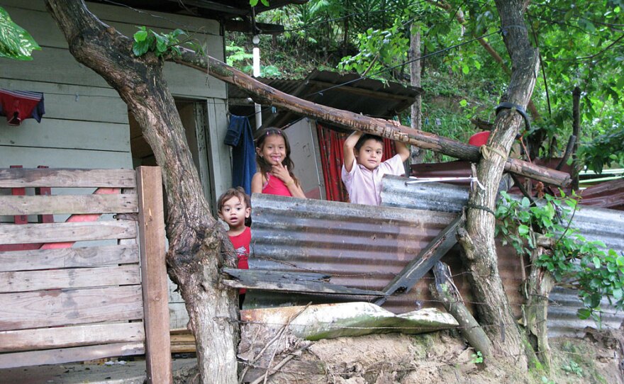Children pose outside a shack in Ocotillo. Residents say there is no place to work in the area — and it is too expensive to commute to where the jobs are.