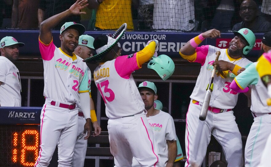 San Diego Padres' Manny Machado (13) celebrates with teammates after hitting a two-run home run against the San Francisco Giants during the seventh inning of a baseball game at Alfredo Harp Helu Stadium in Mexico City, Saturday, April 29, 2023. (AP Photo/Fernando Llano)