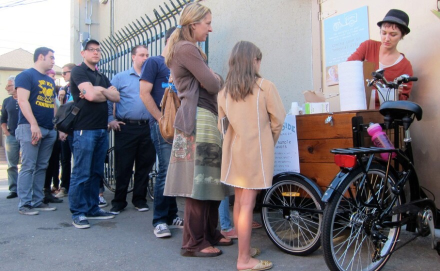 Curbside Creamery's Tori Wentworth dishes out free samples at a recent First Friday event held in Oakland's Temescal Alley.