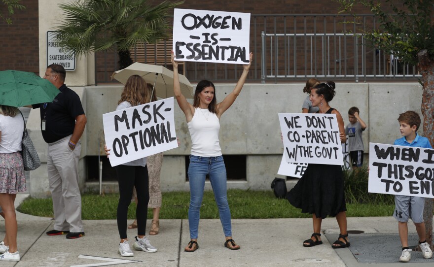 Families protest any potential mask mandates before the Hillsborough County School Board meeting last month in Tampa, Fla.