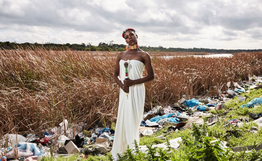 Belinda Qaqamba Ka-Fassie, a post-graduate student in education at Stellenbosch University, wears a dress that resembles the white blanket typically worn at a male circumcision<em>. </em>Her headpiece and beaded stick, both handmade, are traditionally part of a bride's ensemble. The 24-year-old designs her dresses, often choosing local fabrics.
