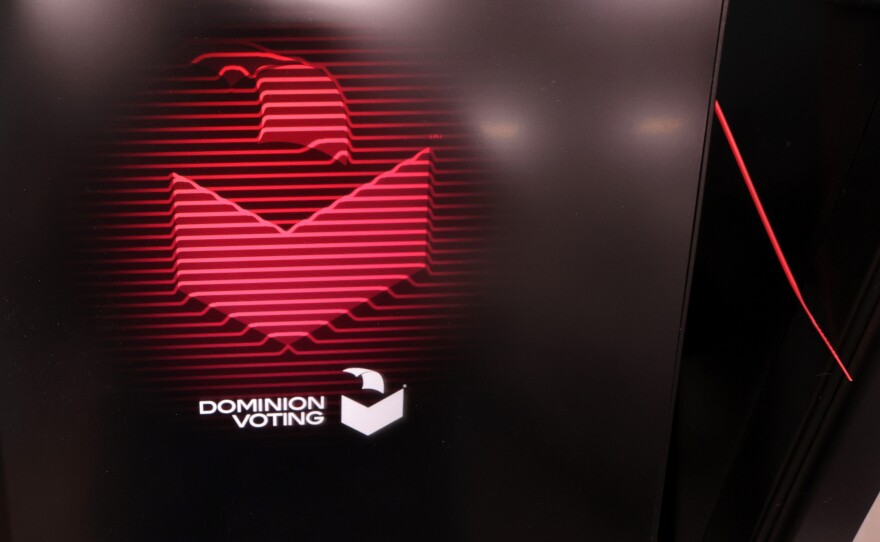 A Dominion Voting logo appears on a voting machine as it is tested while Clark County Election Department workers set up a polling place in Las Vegas last year.