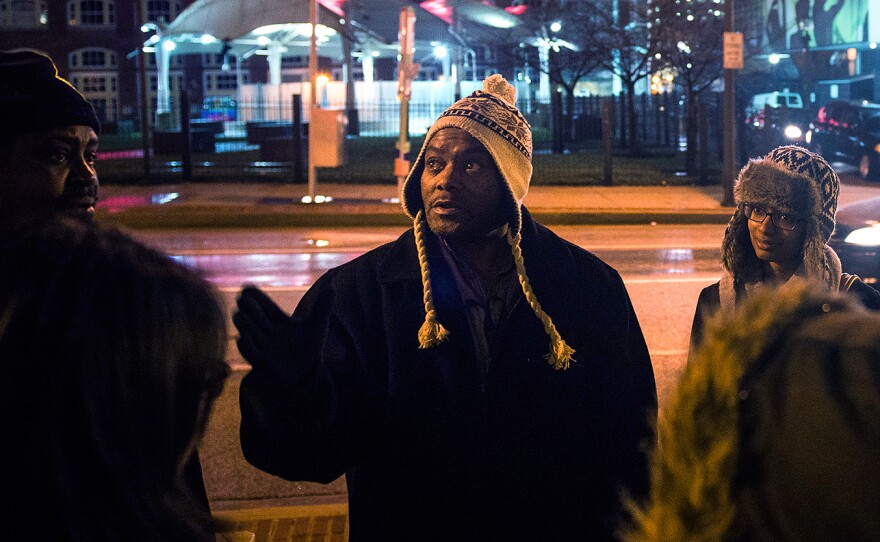Tony Simmons leads a group of Johns Hopkins University students on a "justice walk" of downtown Baltimore, where they learn about public policy, providing services, and the connections between income inequality and health.