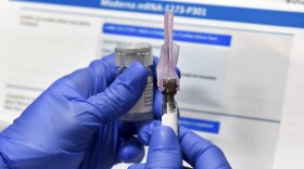 In this July 27, 2020, file photo, a nurse prepares a shot as a study of a possible COVID-19 vaccine, developed by the National Institutes of Health and Moderna Inc.