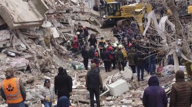 Rescue workers search for survivors under the rubble of a collapsed building in Diyarbakir, southeastern Turkey, on Monday. A powerful earthquake struck southeast Turkey and northern Syria.