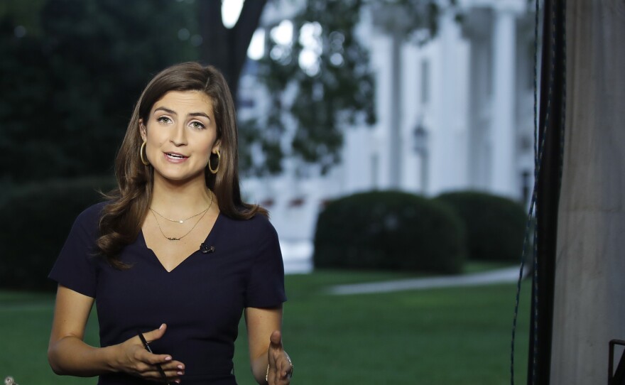 CNN White House correspondent Kaitlan Collins talks during a live shot in front of the White House on Wednesday. Collins says the White House denied her access to an open press event because officials found her earlier questions to the president "inappropriate."