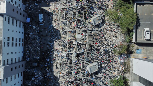 Residents and rescue workers search through the rubble after an earthquake struck Cali, Colombia, Monday, Aug. 10, 2026.