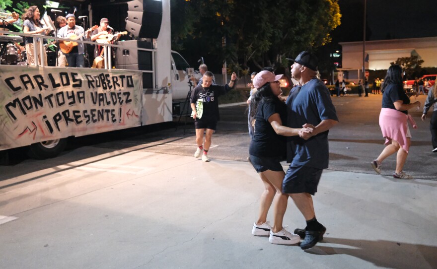 Dancing at an October memorial vigil for a day laborer who was hit by a car while trying to evade arrest by immigration agents.