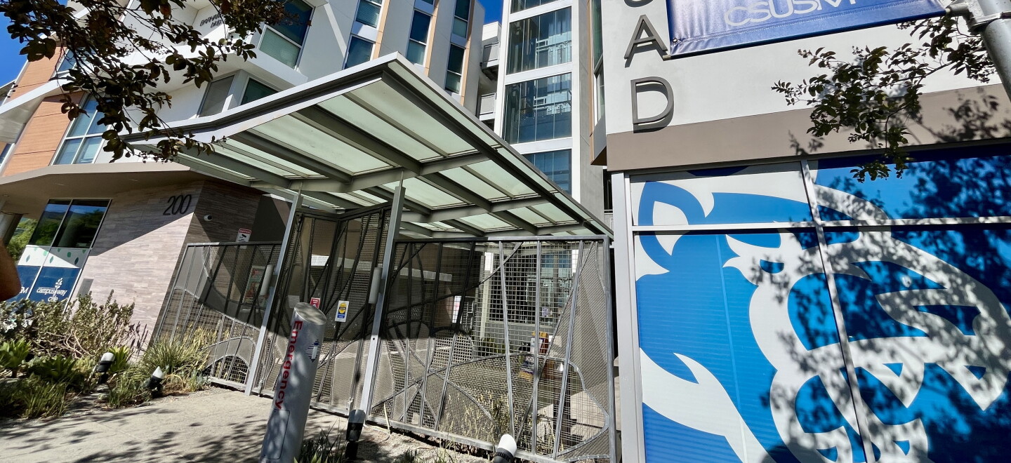 The CSUSM cougar logo is seen under signage for "The Quad" student housing, Oct. 9, 2026.