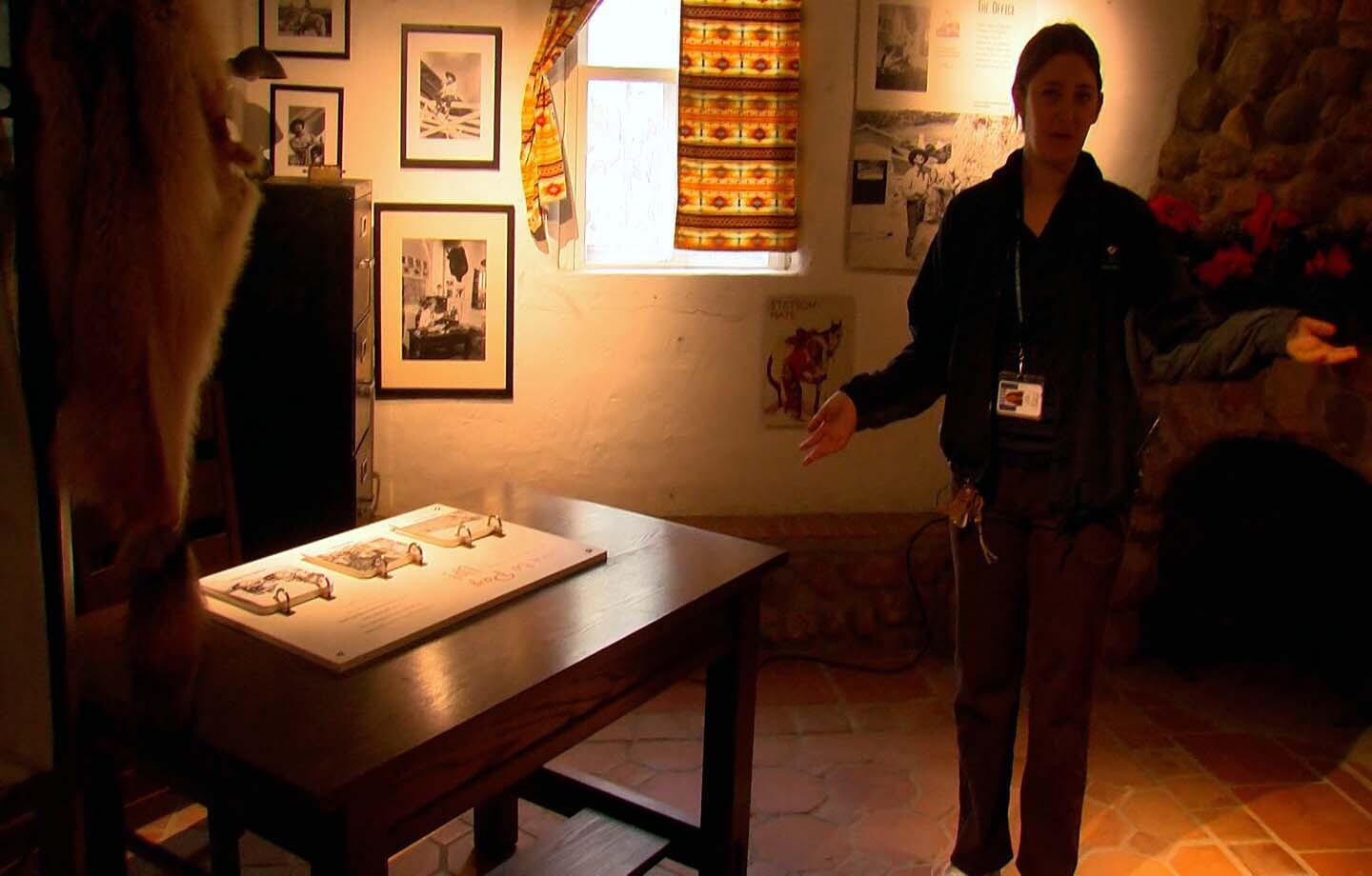 Archivist Emily Brolaski showing off Leo Carrillo's office at the Leo Carrillo Ranch Historic Park, Dec. 11, 2024. The photograph that was the basis for the restoration is displayed in on the wall.