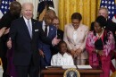 President Joe Biden speaks as Gianna Floyd, the daughter of George Floyd, sits in the chair after Biden signed an executive order in the East Room of the White House, Wednesday, May 25, 2022, in Washington. The order comes on the second anniversary of George Floyd's death and is focused on policing.