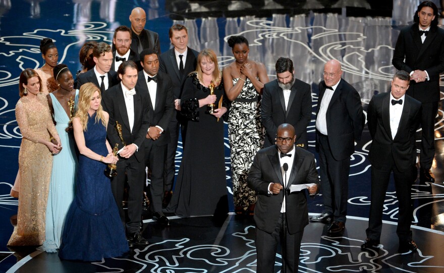 Dede Gardner stands with the <em>12 Years a Slave</em> team as director Steve McQueen accepts the Academy Award for Best Picture on March 2, 2014 in Hollywood, Calif.