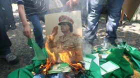 Protesters burn a portrait of Libyan leader Moammar Gadhafi and copies of his Green Book outside the Libyan Embassy in Ankara. Turkey, on Monday. Libyan rebels have taken many parts of the Libyan capital, Tripoli, as they try to oust Gadhafi.