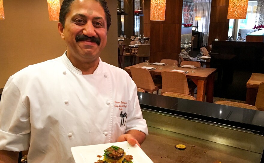 Rasika chef Vikram Sunderam, here with a towering dish of eggplant and potato, says, "Indian cuisine is a very personal cuisine. It's made from family to family, how they like to cook."
