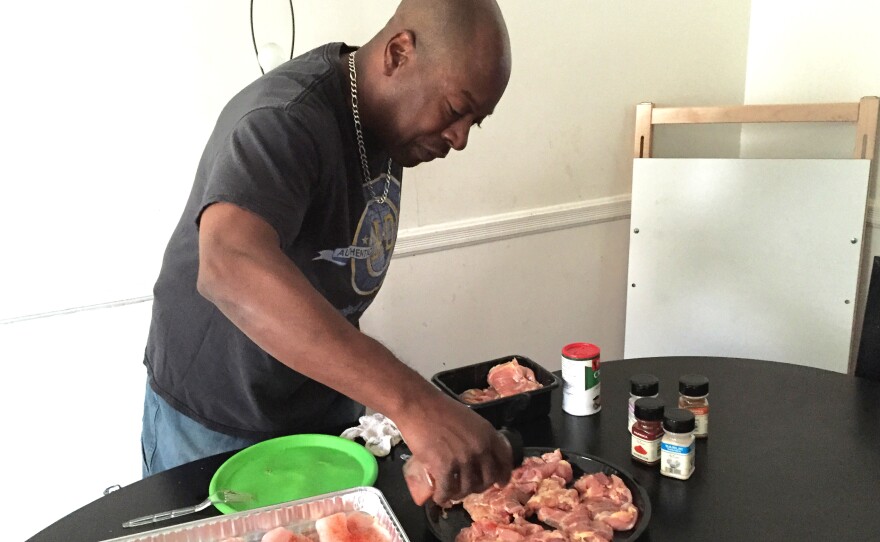 Felipa prepares dinner for his family at their home in West Baltimore, Md.