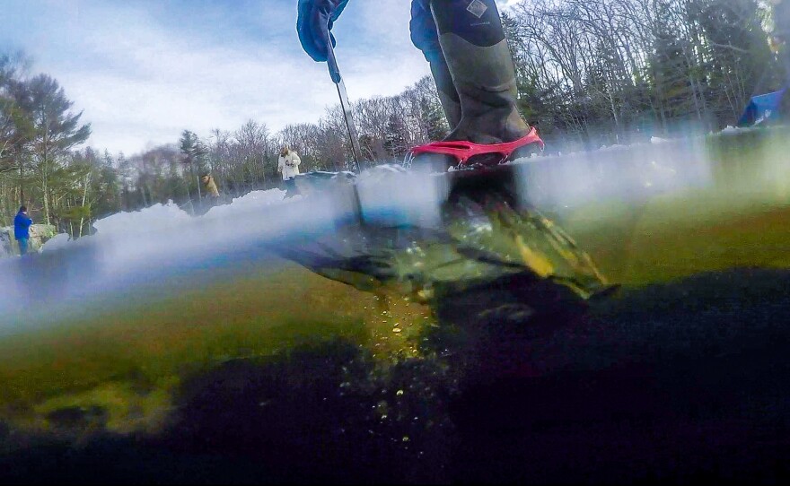 Cutting through the ice on Thompson pond