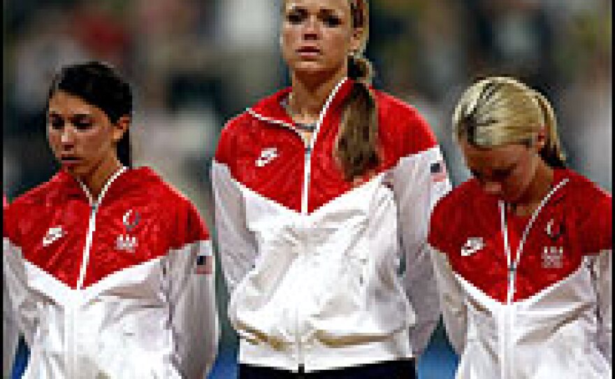 Andrea Duran (from left), Jennie Finch and Caitlin Lowe of the United States prepare to receive their silver medals after their team lost, 3-1, to Japan during the women's final medal softball game in Beijing.