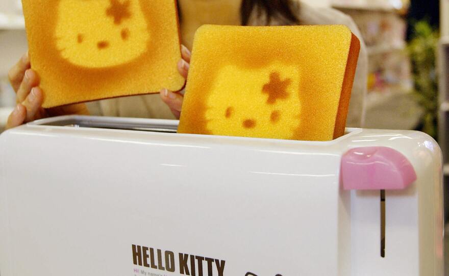 A Sanrio employee displays a Hello Kitty designed toaster celebrating Hello Kitty's 30th birthday in 2004.