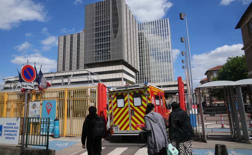 An ambulance enters the Bichat Hospital where a woman who tested positive for hantavirus remains in intensive care, in Paris, Tuesday, May 12, 2026.