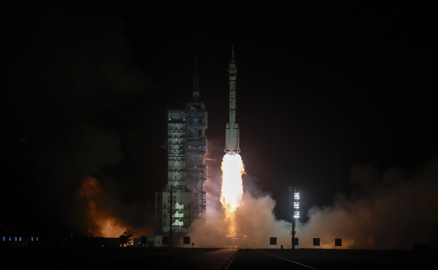 A Long March rocket carrying a crew of Chinese astronauts in a Shenzhou-18 spaceship lifts off at the Jiuquan Satellite Launch Center in northwestern China on Thursday.