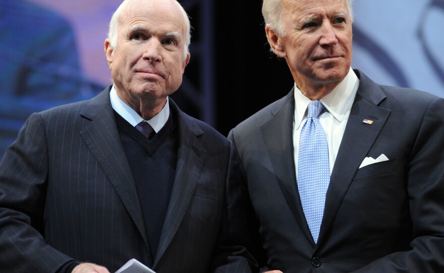 Sen. John McCain, R-Ariz., receives the Liberty Medal from former Vice President Joe Biden (right) in October 2017. Biden is one of many pallbearers who will serve at ceremonies honoring McCain this week.