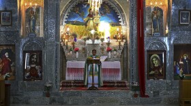 Friar Gabriel Tooma leads Mass at the Chaldean Church of the Virgin Mary of the Harvest, in al-Qoush, a 7th century monastery built into a hill overlooking Alqosh, a village of some 6,000 inhabitants about 31 miles north of Mosul, northern Iraq, June 15, 2014.  