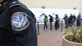Pedestrians crossing from Mexico into the United States at the Otay Mesa Port of Entry wait in line, Dec. 10, 2015.
