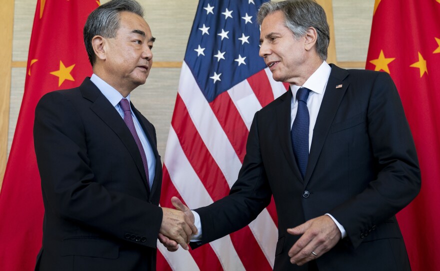 U.S. Secretary of State Antony Blinken (right) shakes hands with China's Foreign Minister Wang Yi during a meeting in Nusa Dua on the Indonesian resort island of Bali on Saturday.