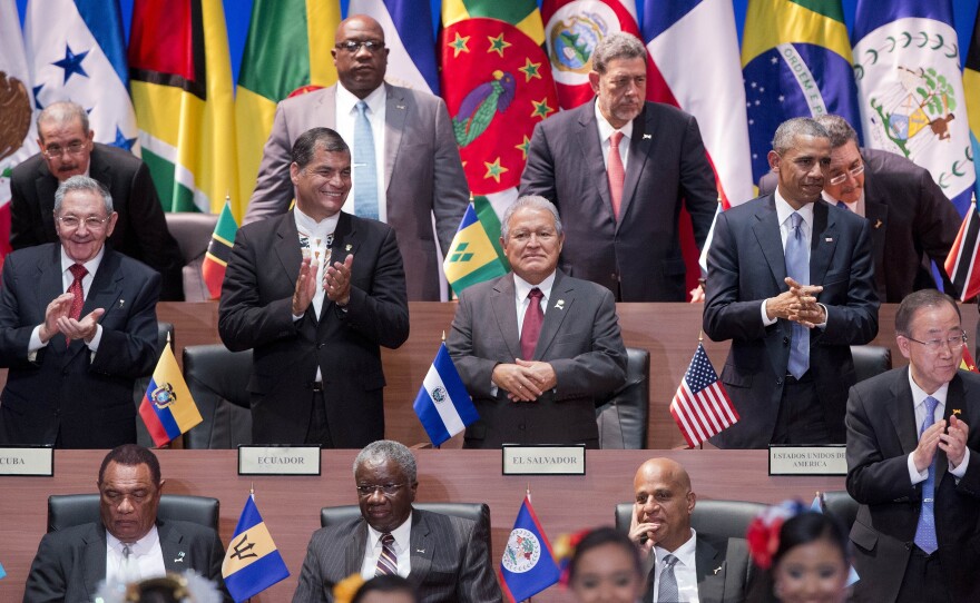 President Obama (right, middle row) and Cuba's President Raul Castro (left) applaud with other leaders during the the Summit of the Americas in Panama City on Friday.