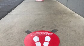 A sign on the ground advising of the store's COVID-19 prevention policies outside Target in the South Park neighborhood of San Diego County. Jan. 26, 2021. 