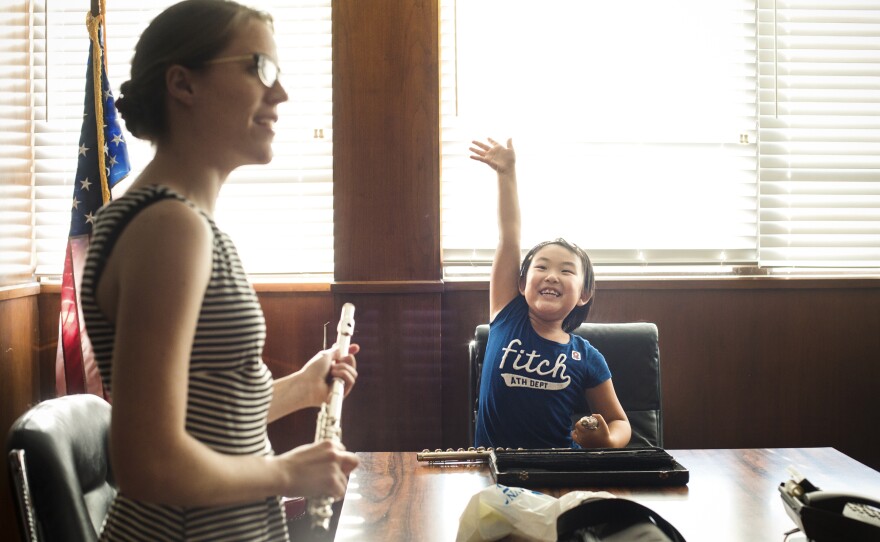 Student Cinee Hong eagerly waits for flute instructor Kathleen Ellingson's attention. Ellingson, a recent graduate of the University of Southern California, says when she's not teaching kids at Harmony Project, she's giving private lessons or working in the office of a local flute repair shop.