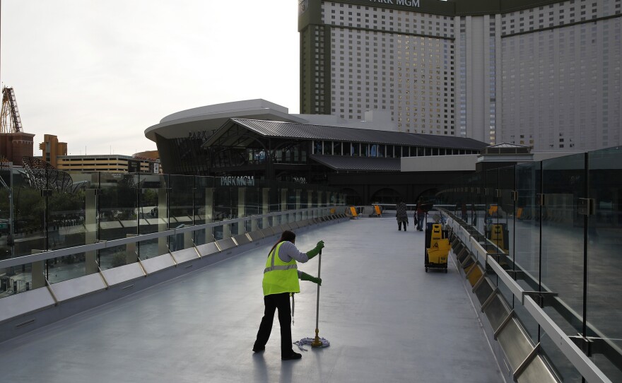 A worker cleans along the Las Vegas Strip, which is nearly empty without the usual crowds as casinos and other businesses are shuttered during the coronavirus outbreak on March 31.