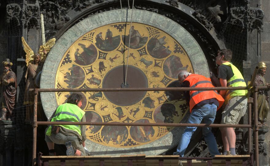 Members of the European Parliament have voted to abolish daylight saving time in the EU. Here, workers remove the calendar dial of Prague's astronomical clock during a renovation of the building in 2017.