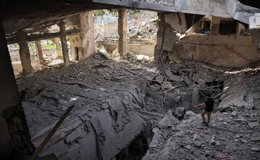 A man walks among debris in a mosque destroyed in an Israeli airstrike in Jibchit, southern Lebanon, Friday, April 17, 2026, following a ceasefire between Israel and Hezbollah.