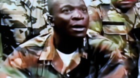 The leader of the junta that seized power in Mali, Army Capt. Amadou Sanogo, announces a curfew in the capital, Bamako, on Thursday, in this photo taken from television.The coup ousted an elected president who was due to step down after a new election next month in the West African nation.