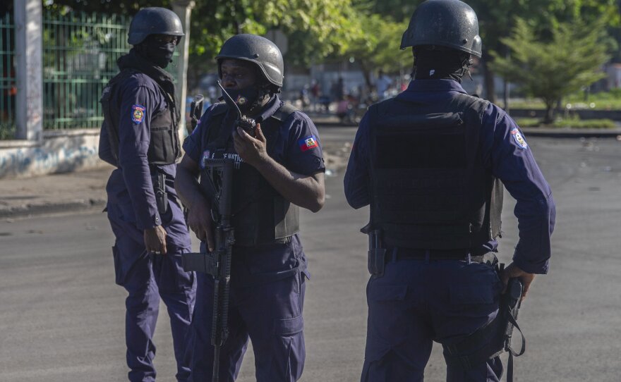 Armed forces secure the area where Haiti's Prime Minister Ariel Henry placed a bouquet of flowers in front of a memorial to independence hero Jean-Jacques Dessalines in Port-au-Prince, Haiti, on Sunday. Haitian police are working with U.S. officials and are in contact with the kidnappers who abducted a group of American-based missionaries on Saturday.