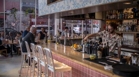 A bartender pours a drink at L'Oca d'Oro, an Italian restaurant in Austin, Texas, that offers a weekly promotion where guests can pay what they want.