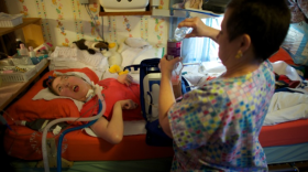Olivia Welter breathes with the help of the portable ventilator on the back of her wheelchair. She can't speak; she can't move. Her eyes are wide open — she can't even close her eyelids. She has been severely disabled since birth.