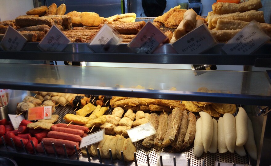 Food offerings including squid dough fritters at Hawker Center, Airport Road, Singapore. The island nation is famous for its street food, a mix of Chinese, Indian, Malay and Indonesian dishes.
