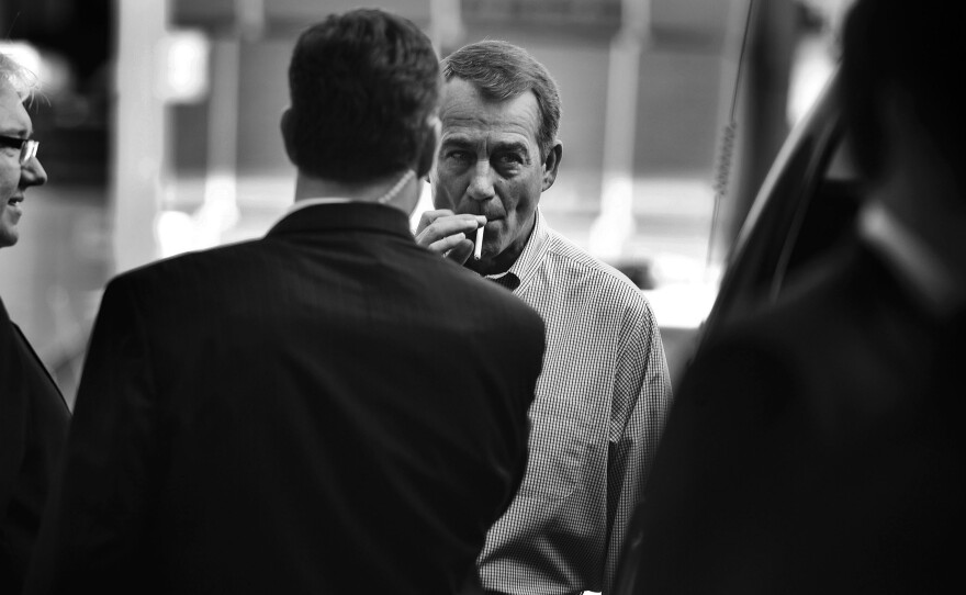 John Boehner smokes a cigarette after a news conference outside of Tart Lumber Company in Sterling, Va., in 2010.