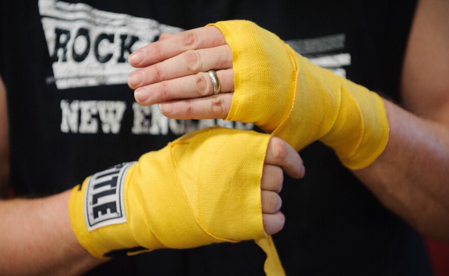 Quaglia unwraps his hands after a punching exercise.