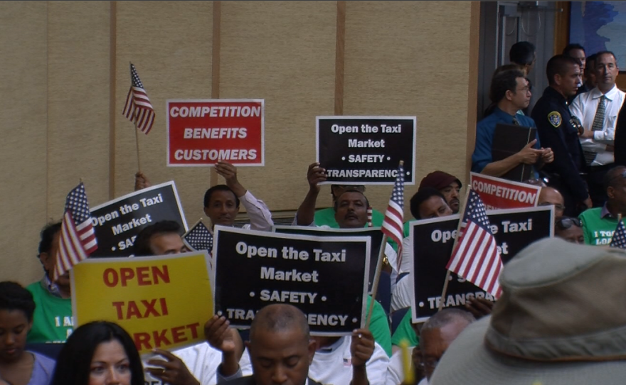 Members of taxi driver association United Taxi Operators of San Diego show their support Sept. 18, 2014 for a proposal to lift the cap on taxi permits in the city