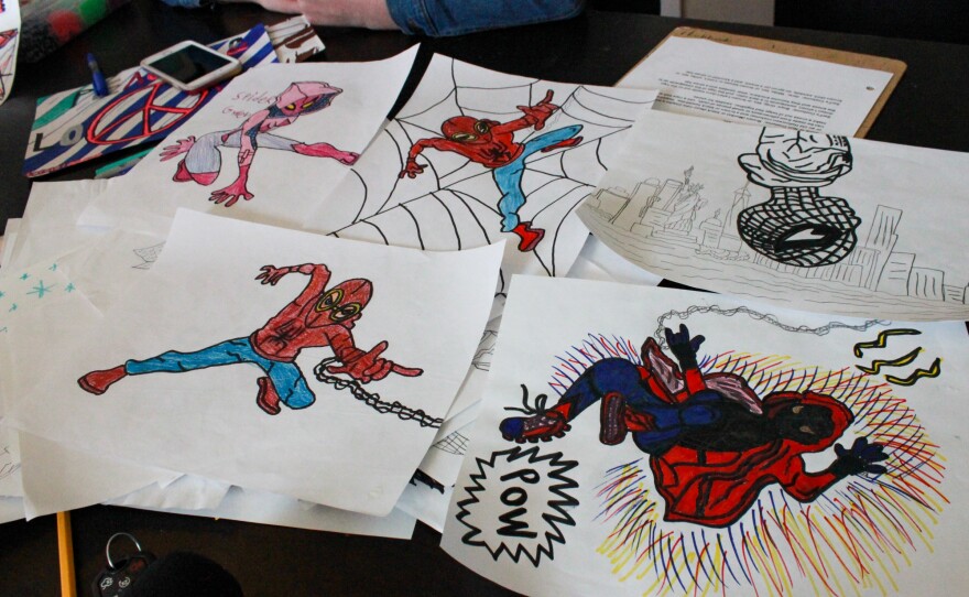 Drawings made by Jenn and Jason's 15-year-old son lie on the family's dining room table in their home in central Illinois. Though his angry outbursts reveal a violent side, his parents say that most of the time he is "kind, funny and smart" — a teen who enjoys drawing pictures of superheroes.